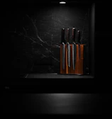 a bunch of knives that are on a shelf