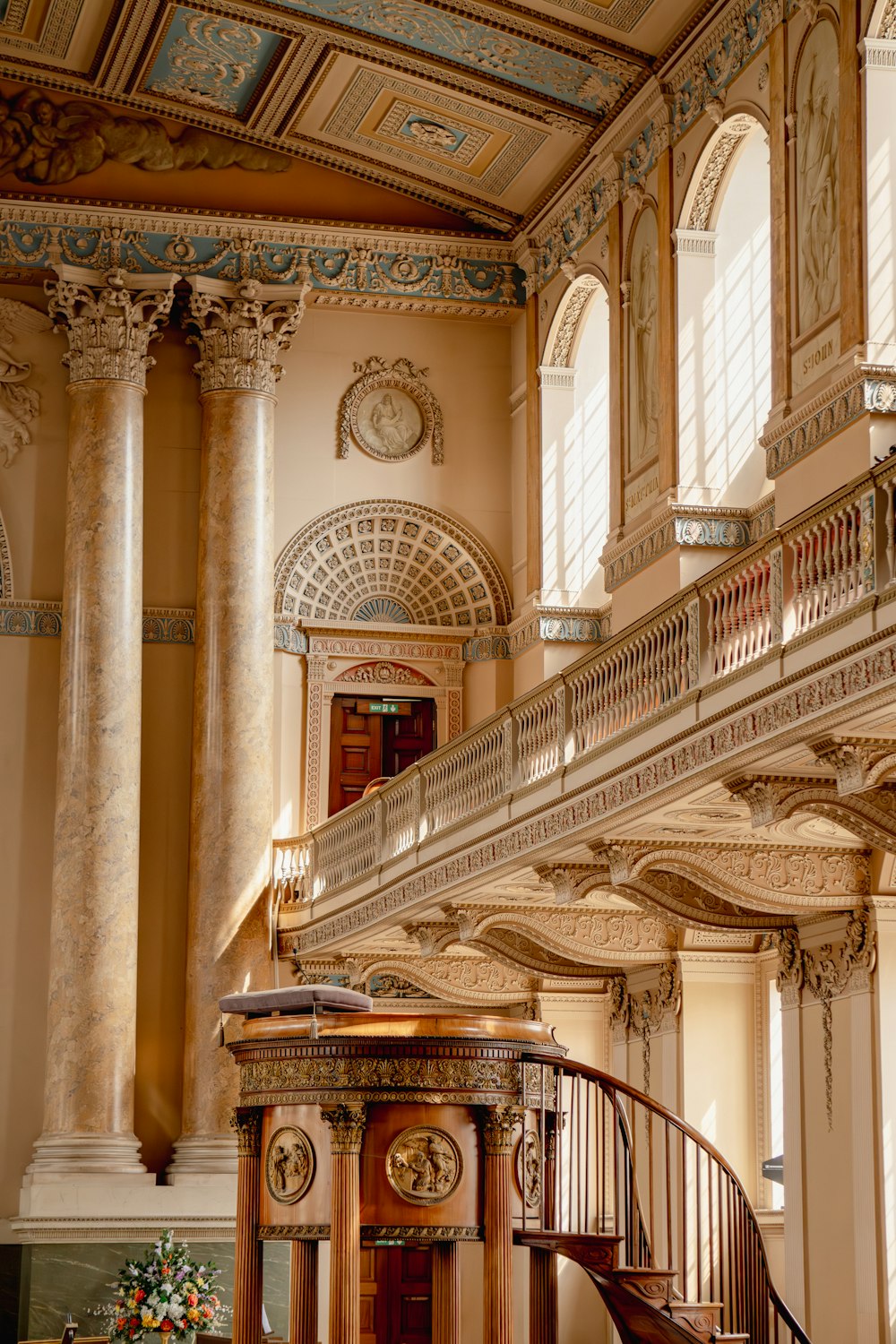 a staircase in a building with a clock on the wall