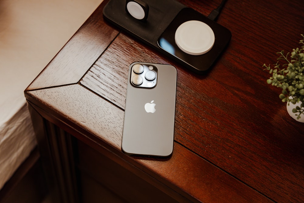 an iphone is sitting on a wooden table