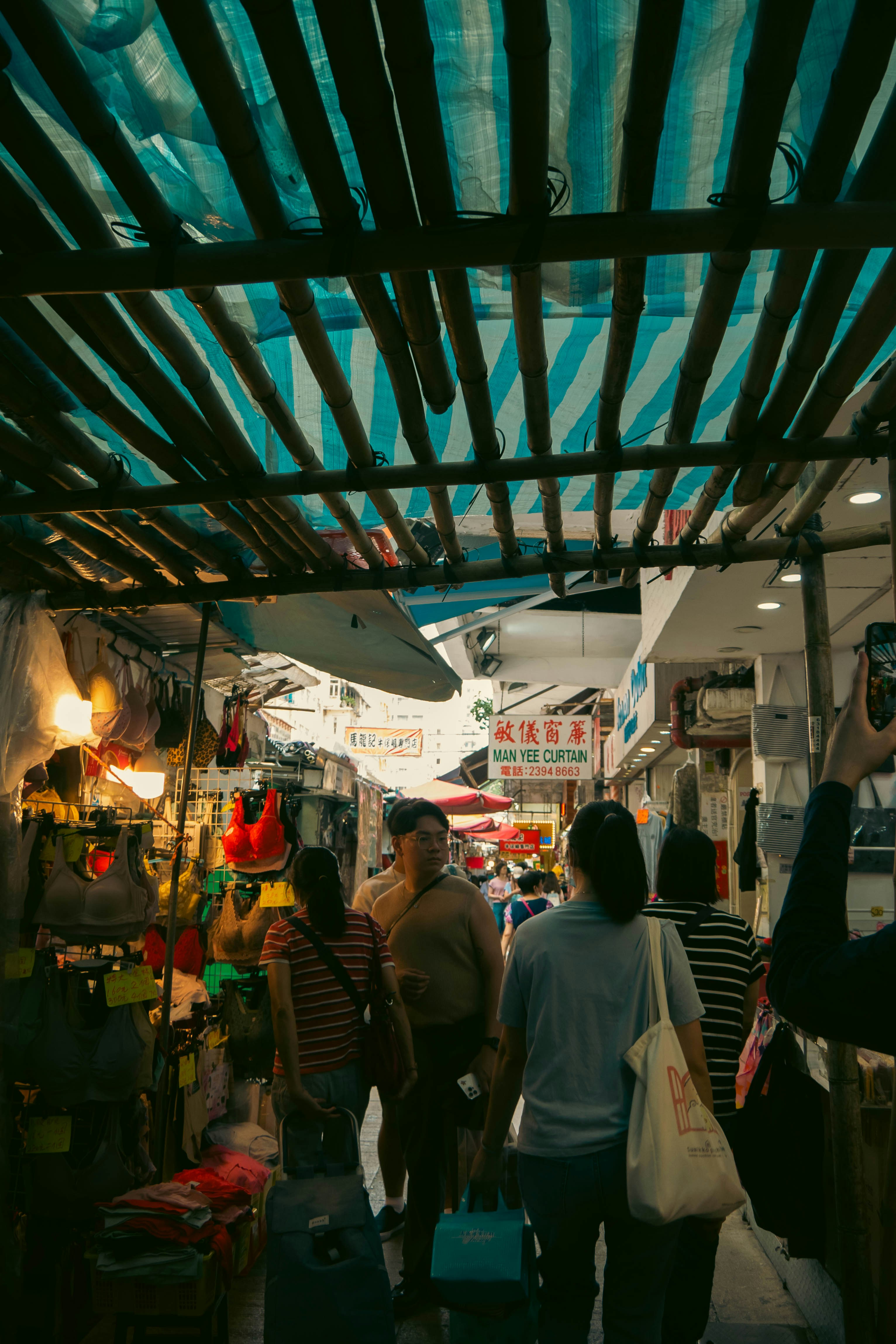 a group of people walking through a market