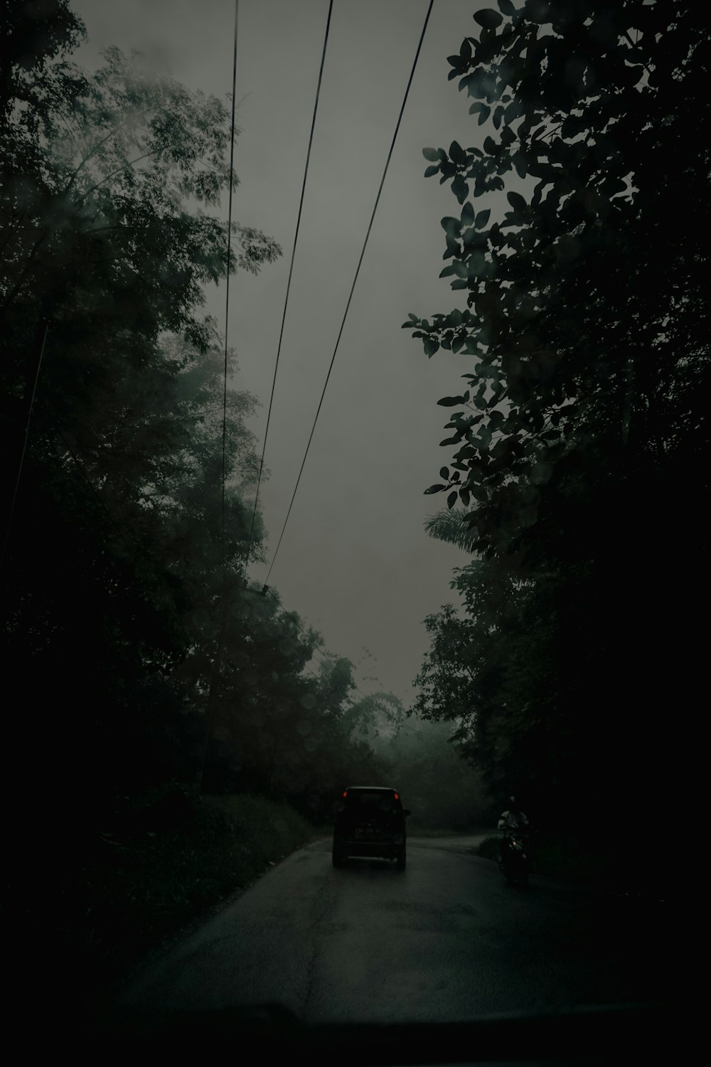 a car is driving down a dark road