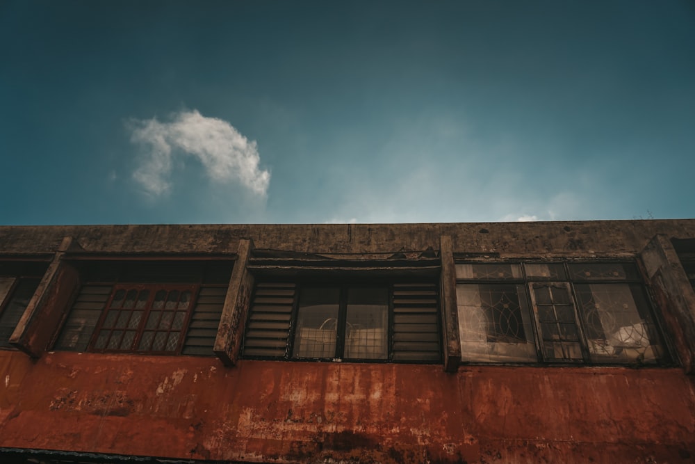 an old building with windows and shutters under a blue sky