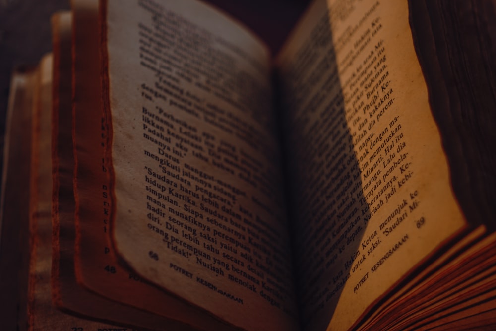 an open book sitting on top of a wooden table