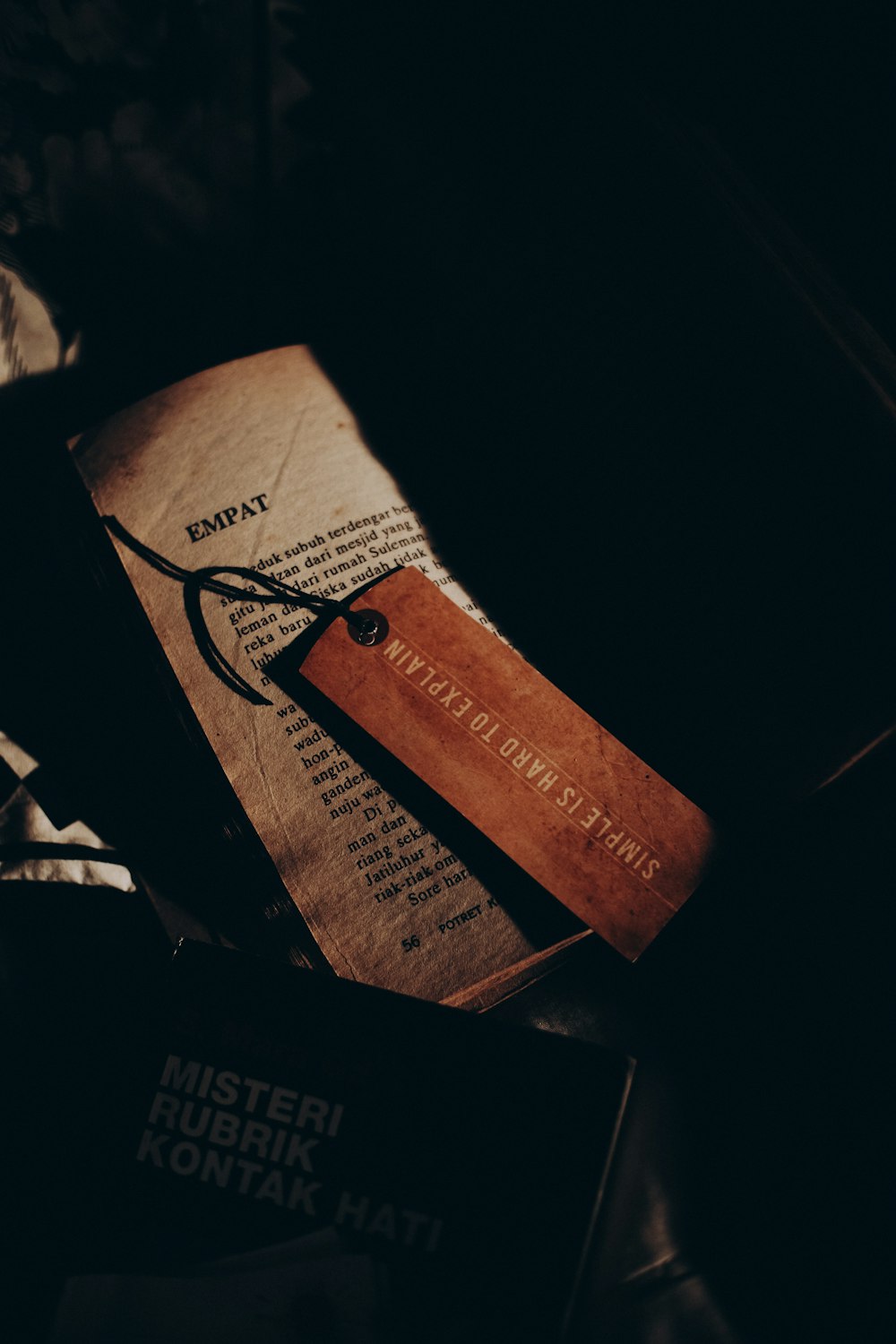 a book with a leather bookmark on top of it