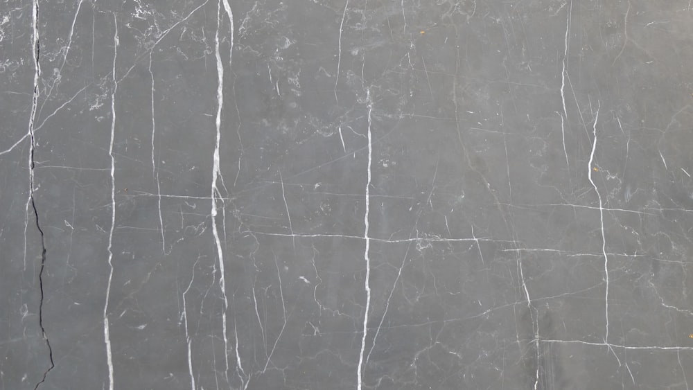 a black and white marble wall with lines on it