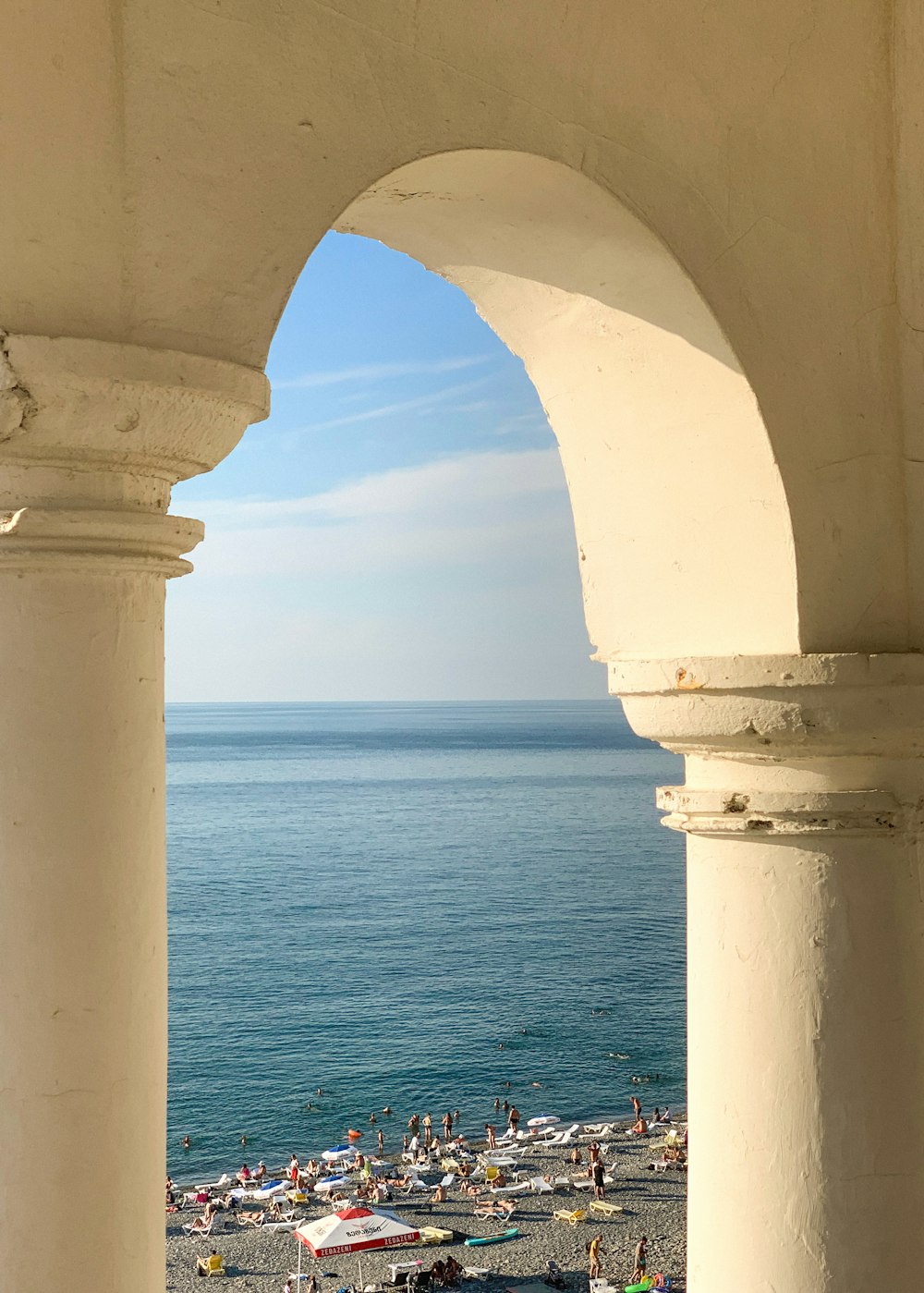 a view of a beach through an archway