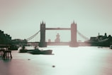 A crisp, elegant photo of the Tower Bridge at dusk with soft navy blue skies.