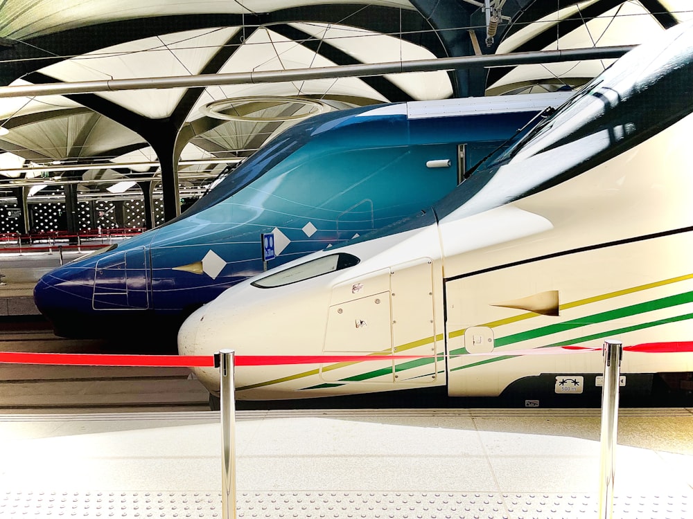 two trains parked next to each other in a train station