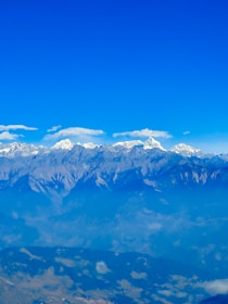 Snow-capped peaks of the Atlas Mountains under a clear blue sky.