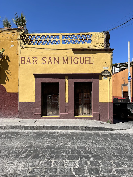 a yellow and brown building with two doors