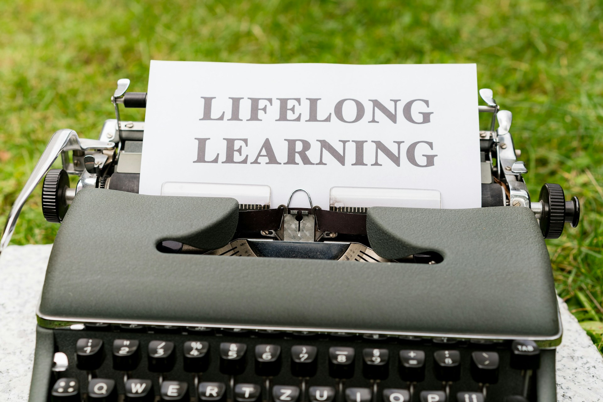 a close up of a typewriter with a sign on it