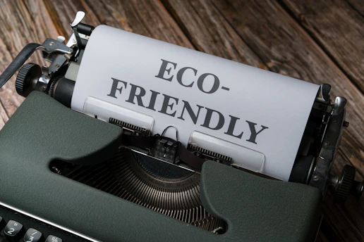 a close up of a typewriter with a paper that reads eco - friendly