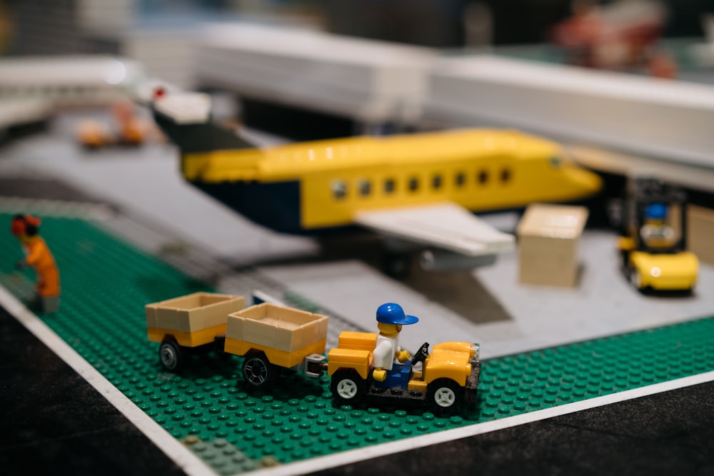 a lego model of a train station with a man and a truck