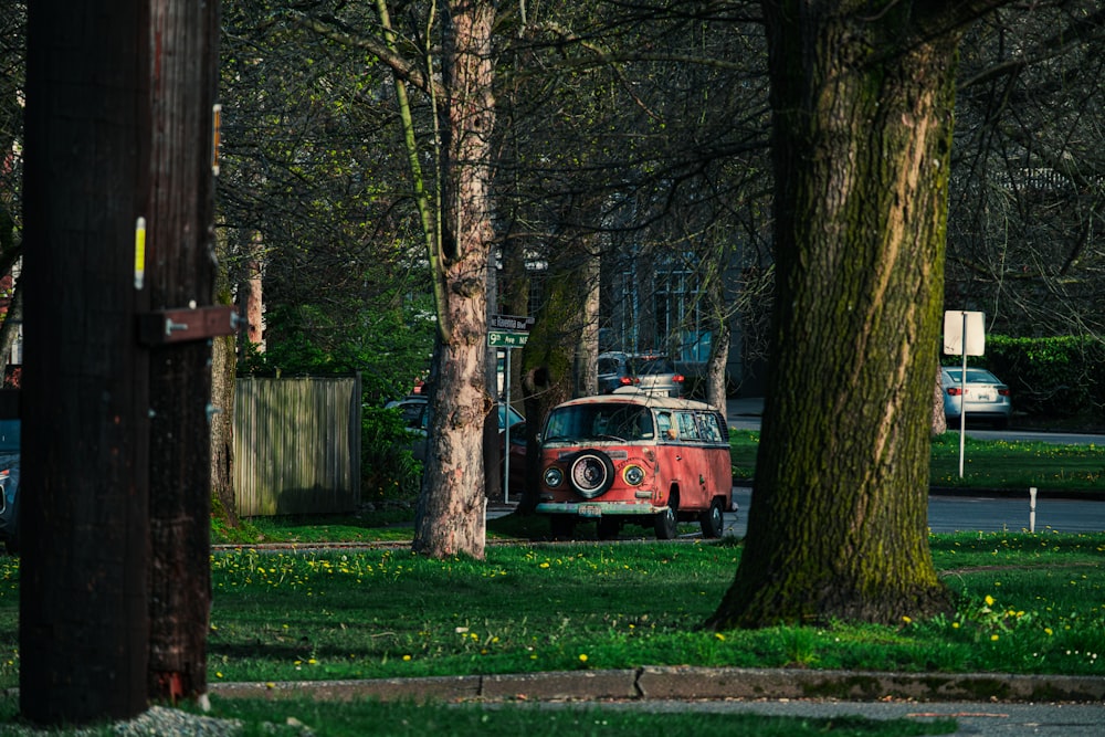 an old vw bus is parked in a park