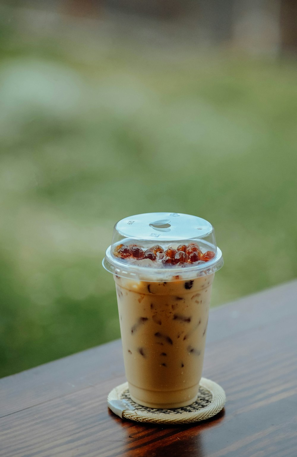 a cup of coffee sitting on top of a wooden table