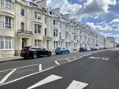 a row of white buildings on a street