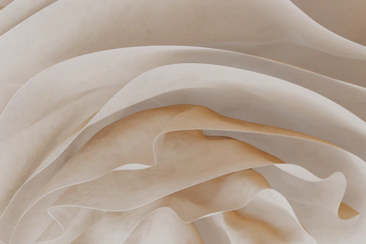 Abstract golden waves flowing softly over a creamy white background, evoking warmth and calm.
