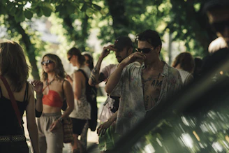 Group of colleagues enjoying a casual outdoor company gathering in a green area.