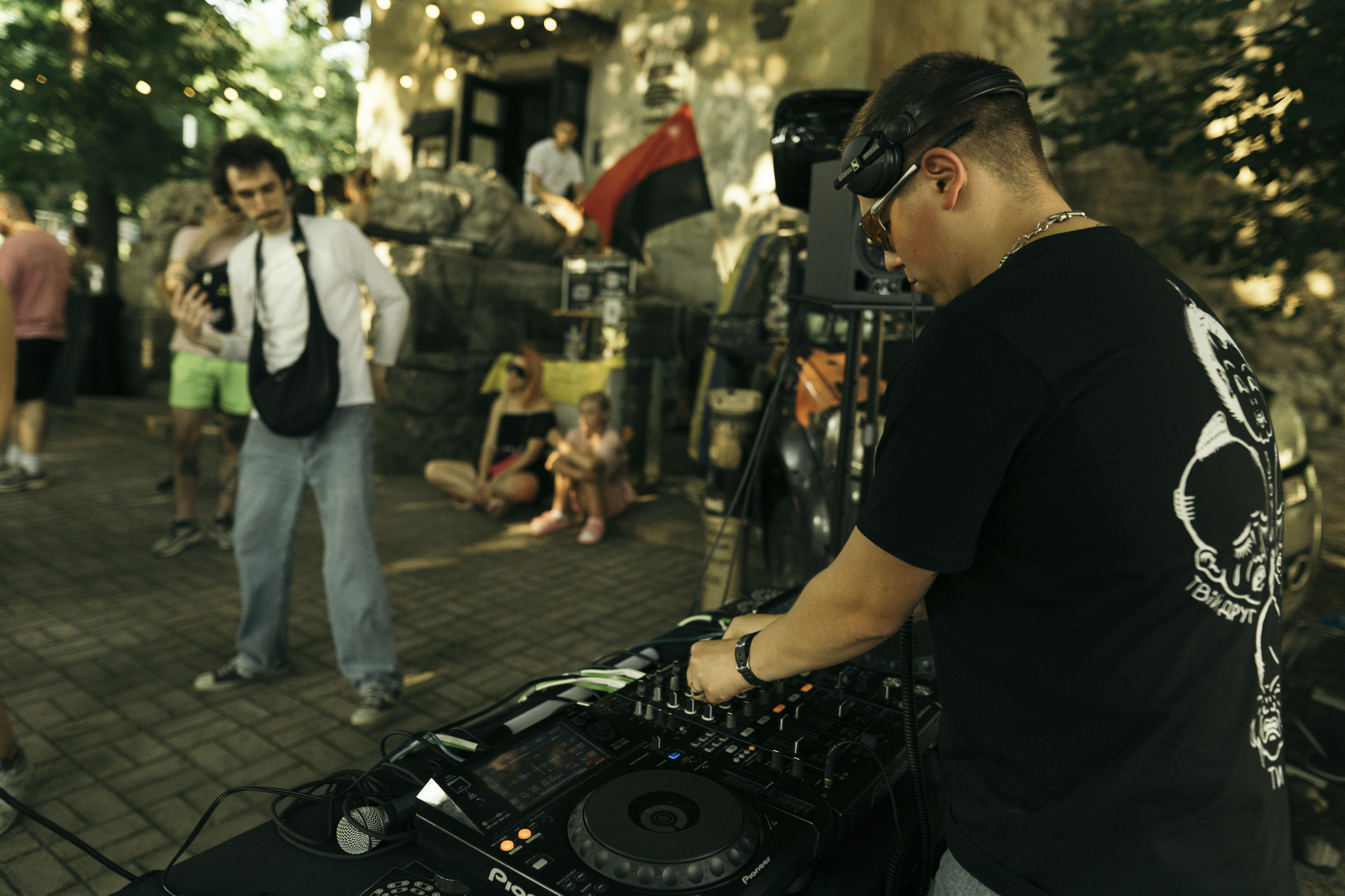 a dj mixing music in front of a group of people