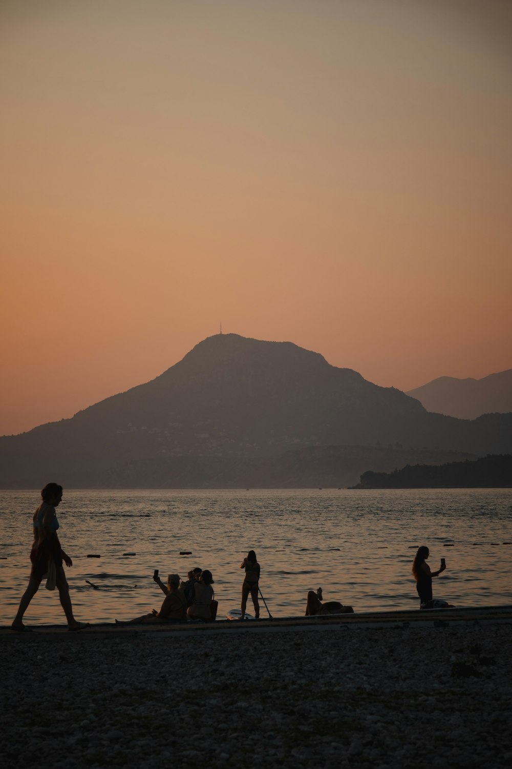 a group of people standing on top of a beach