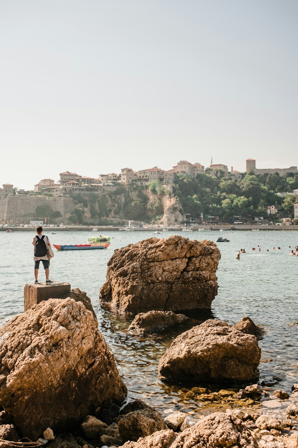 a person standing on a rock in the water