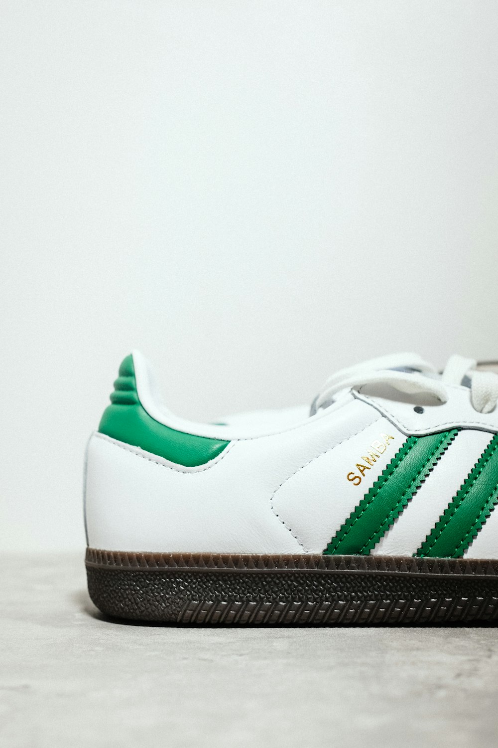 a pair of white and green sneakers on a table