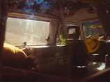 The cozy interior of their self-converted van with warm lighting and travel gear neatly arranged.