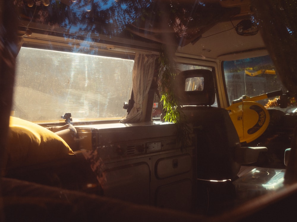 the interior of a camper van with the sun shining through the window