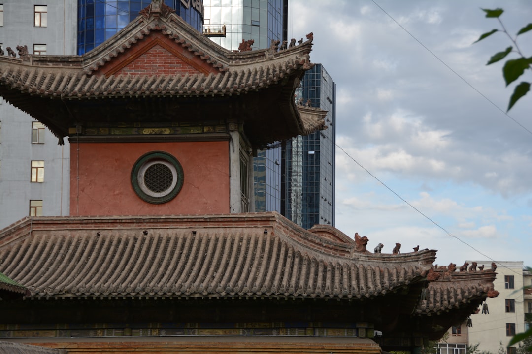 a tall building with a clock on the top of it, Ancient Meets Modern