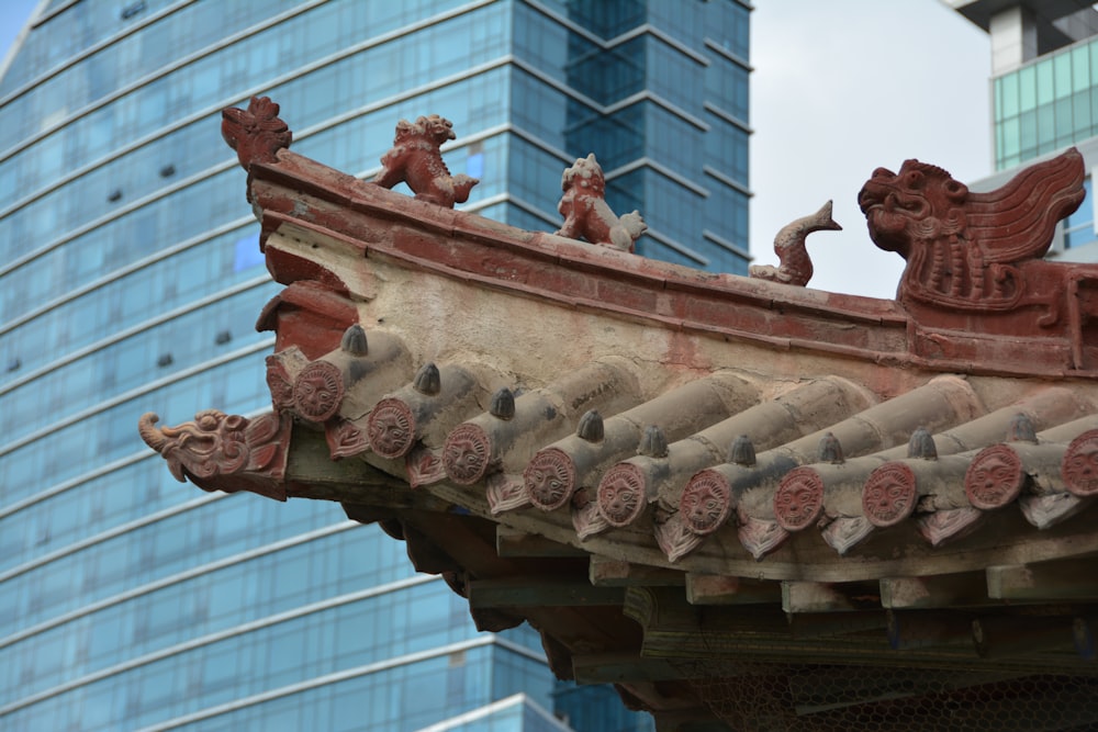 a close up of a roof with a building in the background