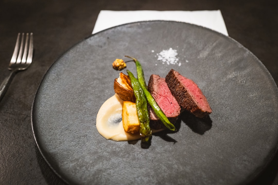 a plate of food on a table with a fork and knife,