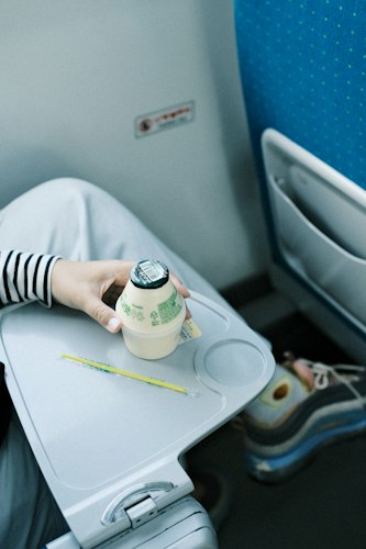 Traveler stretching near a window during an airport layover