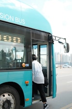 Private passenger getting in a comfortable shuttle bus ready to depart.