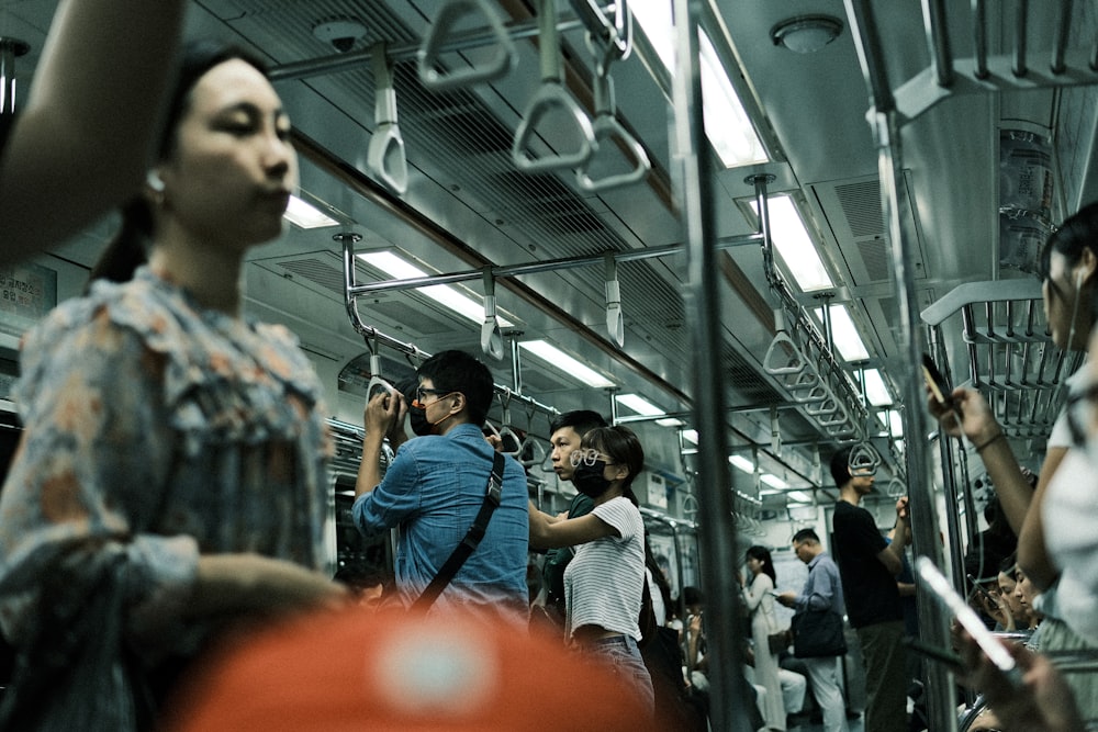 a group of people on a subway train