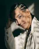 a woman with braids and a white shirt