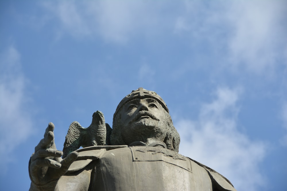 a statue of a man with a bird on his arm