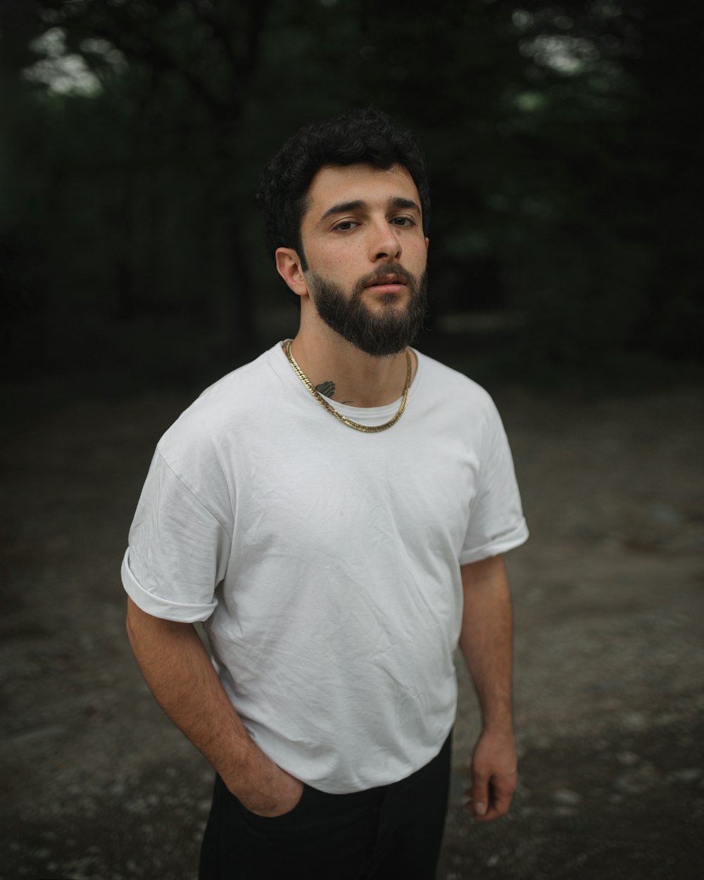 a man with a beard wearing a white shirt