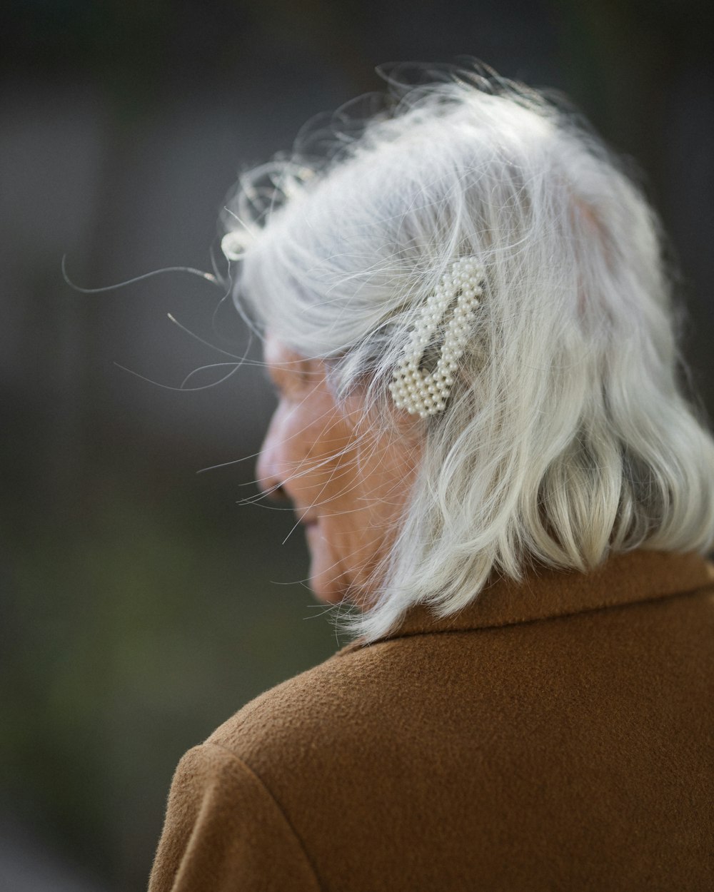 a woman with white hair and a bow in her hair