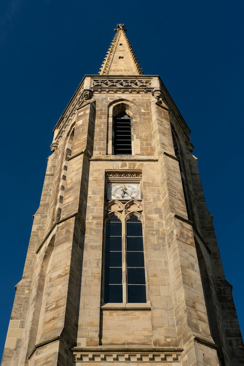a very tall tower with a clock on it's side