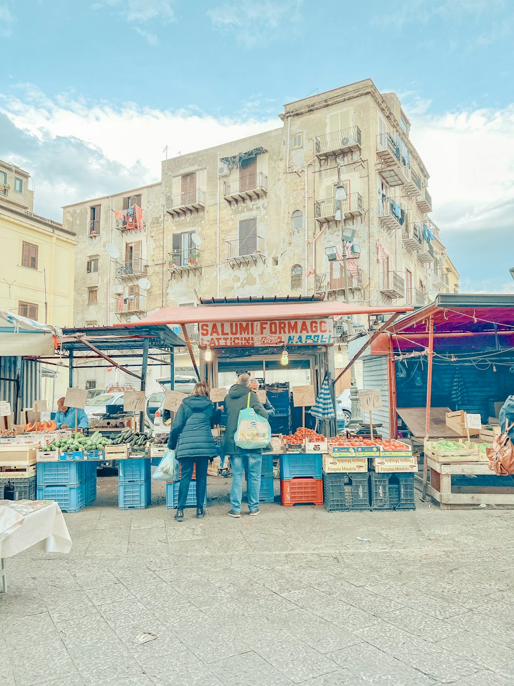 a group of people standing in front of a market