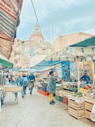 A vibrant street market bustling with colorful stalls and smiling locals.