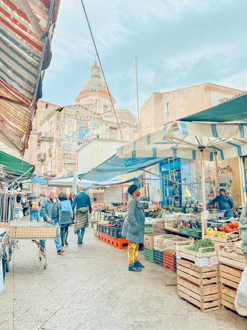 A vibrant street market bustling with colorful stalls and smiling faces