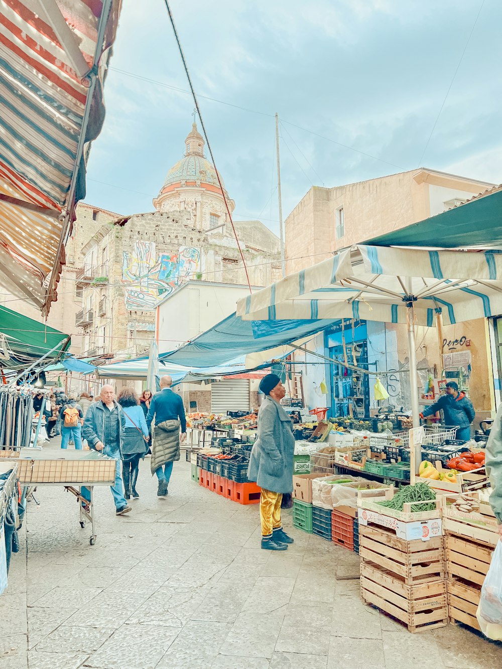 a group of people walking around a market