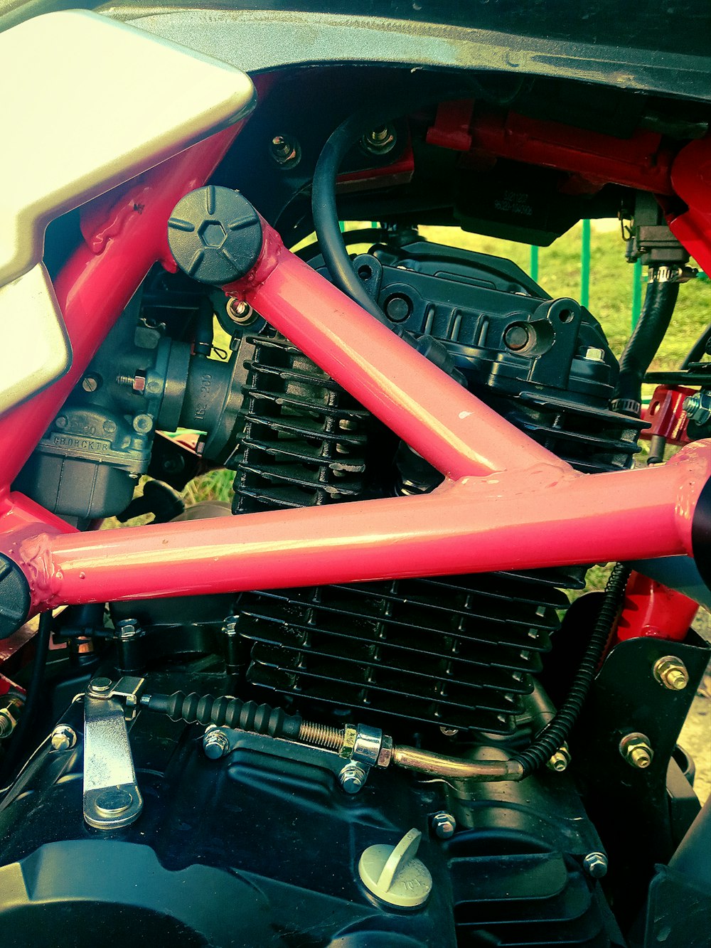 a close up of a red motorcycle engine