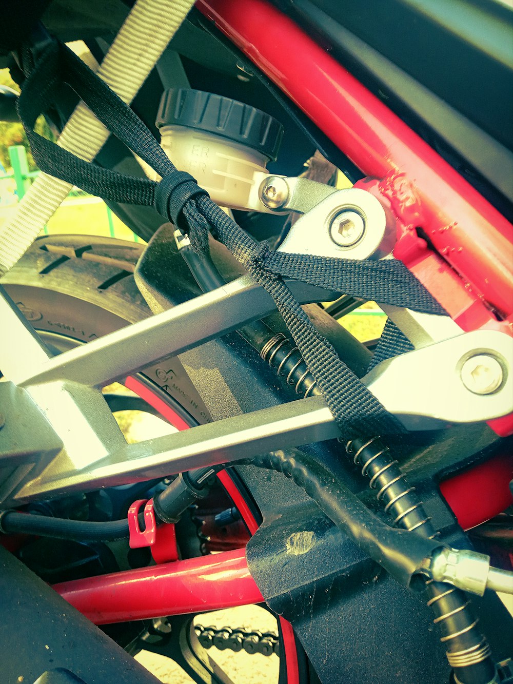 a close up of a red bike with a black handlebar