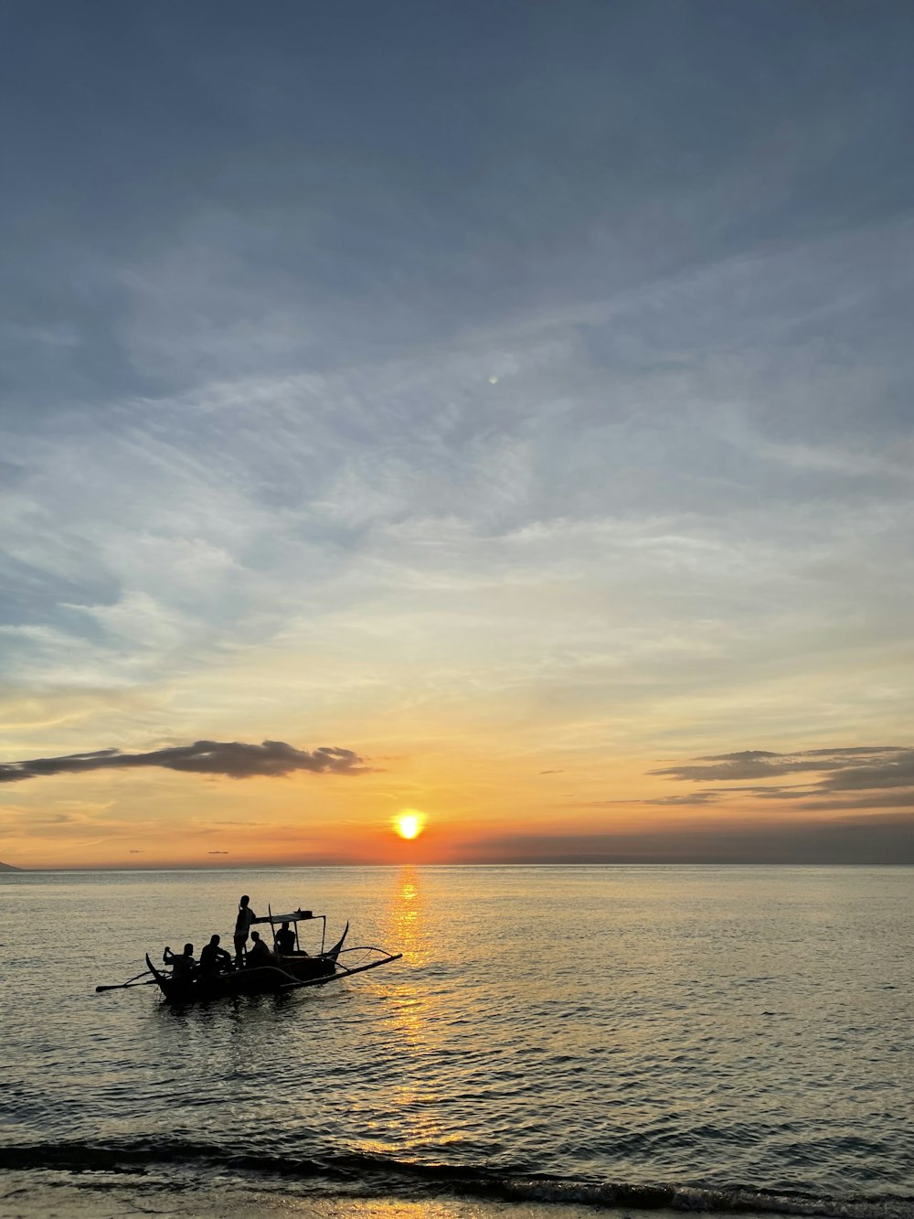 a group of people riding on top of a boat in the ocean