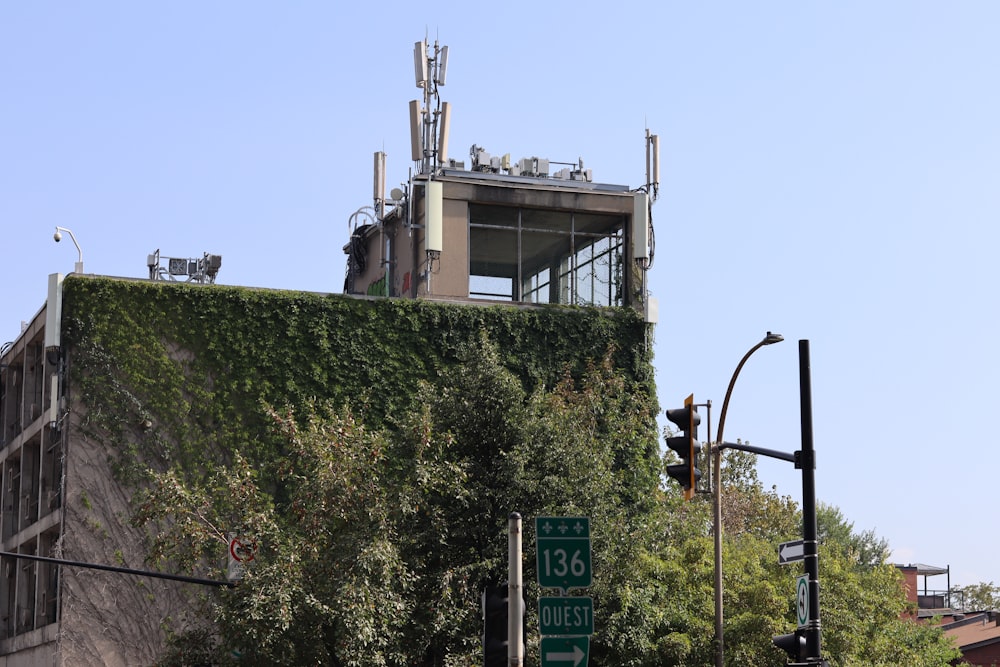 a tall building covered in vines next to a traffic light