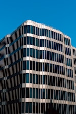 A sleek 3D rendering of a luxury building with glass and steel elements reflecting the sky.