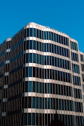 An elegant high-rise building with a sleek facade and panoramic views of the city skyline.