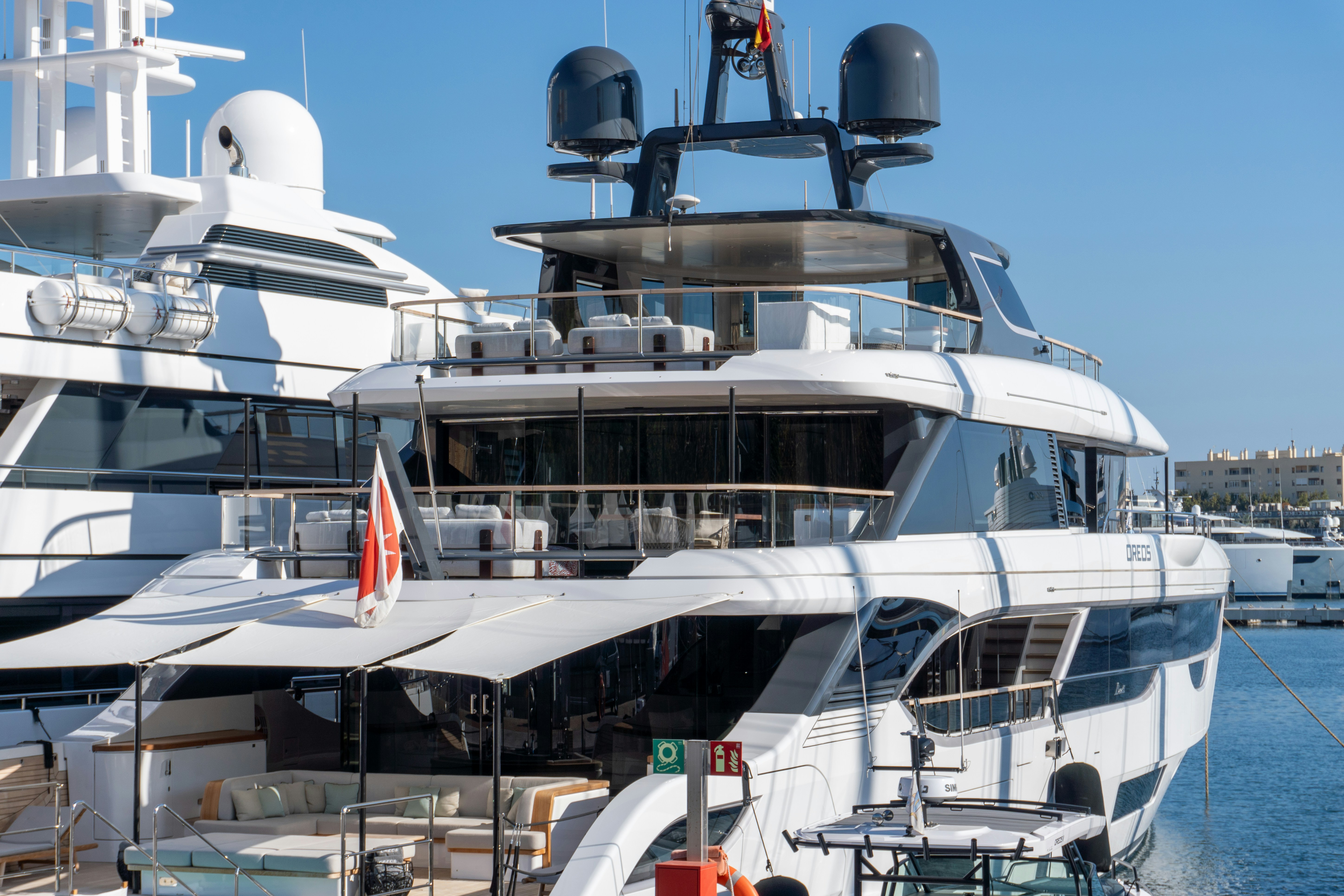 A large white boat docked at a marina